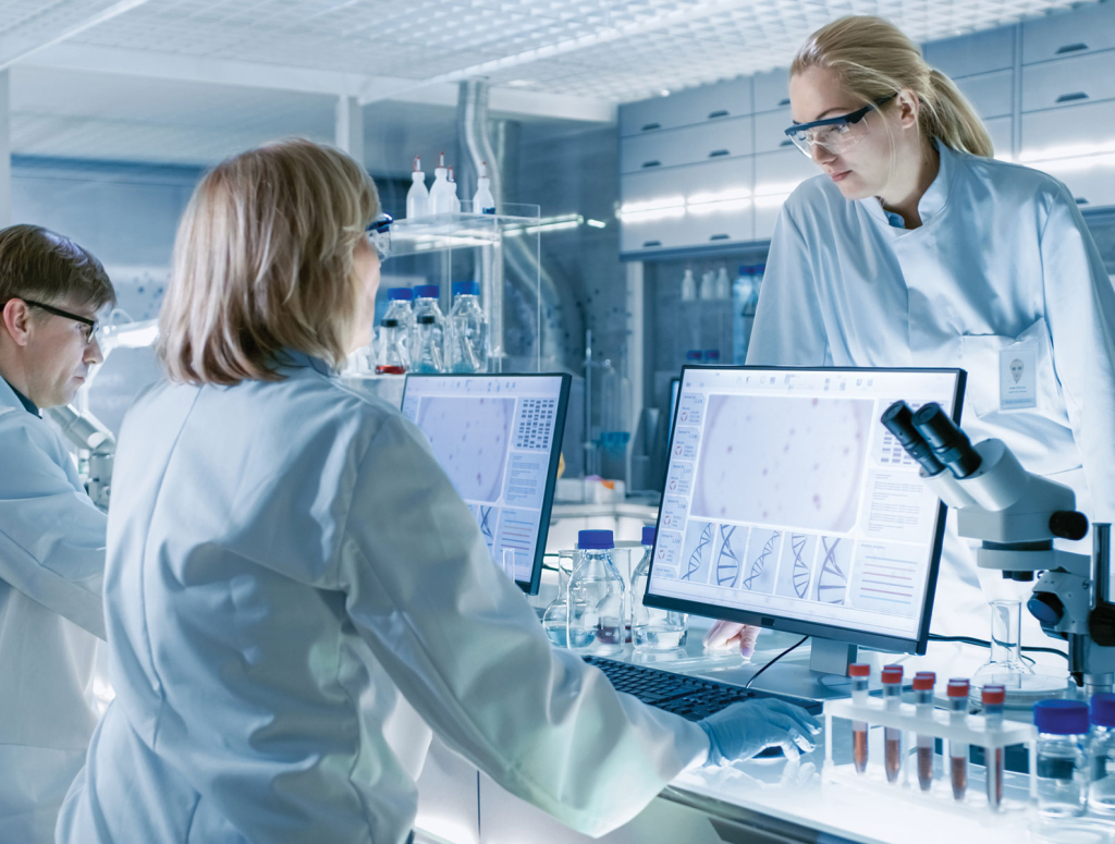 Scientist examining samples under a microscope in a laboratory